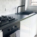 white kitchen with black appliances