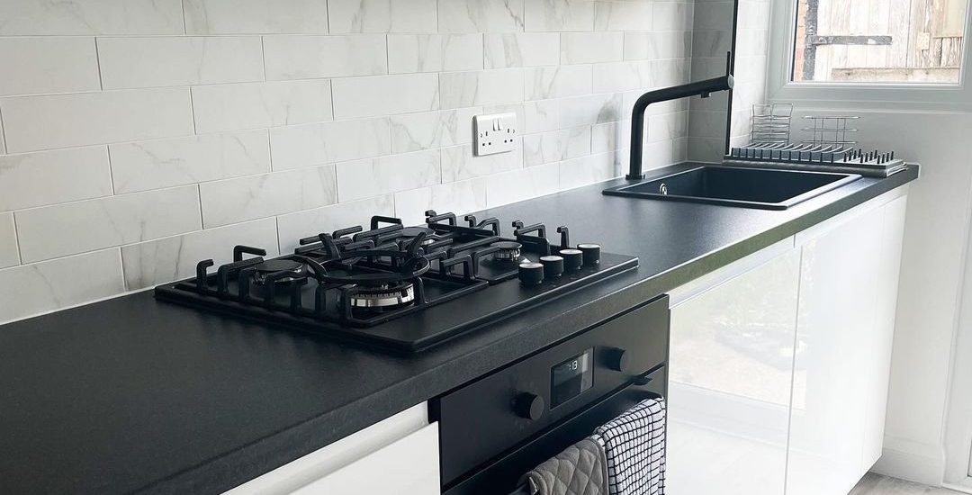 white kitchen with black appliances