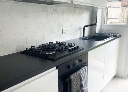 white kitchen with black appliances